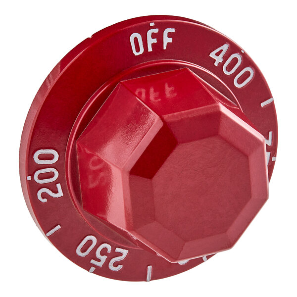 A red Vulcan thermostat knob with white text and a hexagon shape.