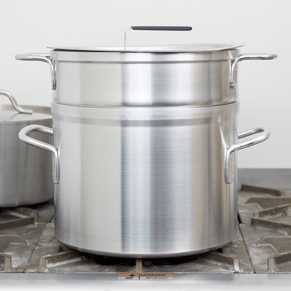 A Vollrath aluminum inset for a double boiler on a stove.