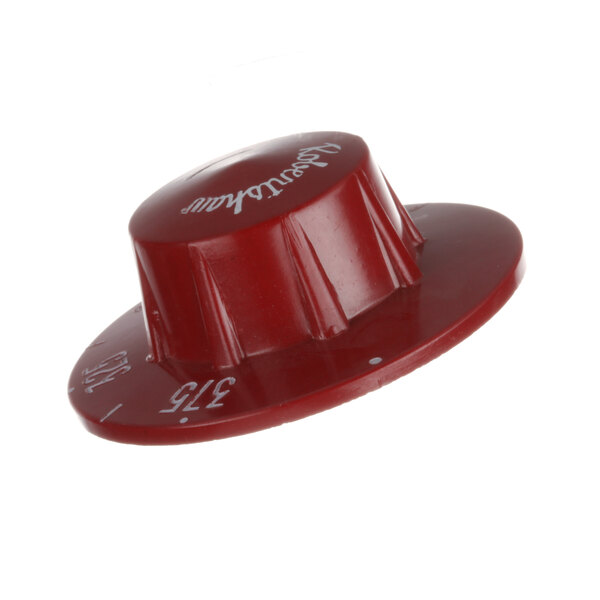 A close-up of a red plastic knob for a Grindmaster-Cecilware coffee machine with white text that reads "Cork"