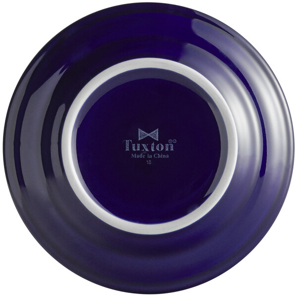 A Tuxton Concentrix cobalt blue china plate with a white rim.