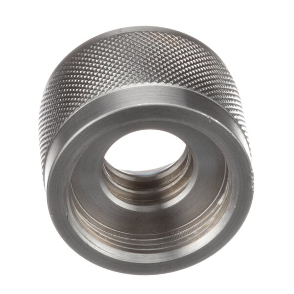 A close-up of a stainless steel threaded nut with a hole.