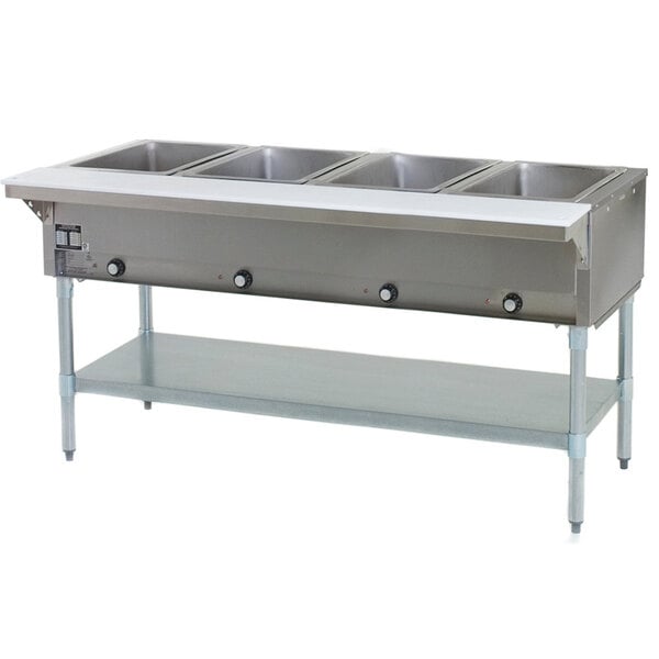 An Eagle Group stainless steel steam table warmer with four pans on a counter.