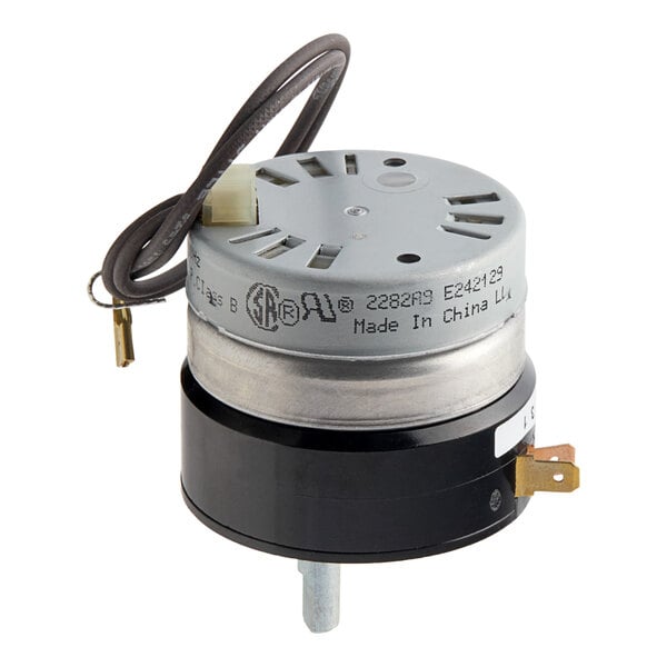 A close-up of the Vulcan 240v timer, a small round black and metal electrical device with wires attached.