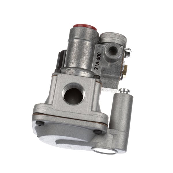 A close-up of a silver metal Groen gas valve with a red button.
