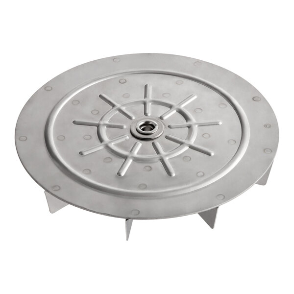 A round metallic component with radial fins and a central bearing, resembling a blower wheel.