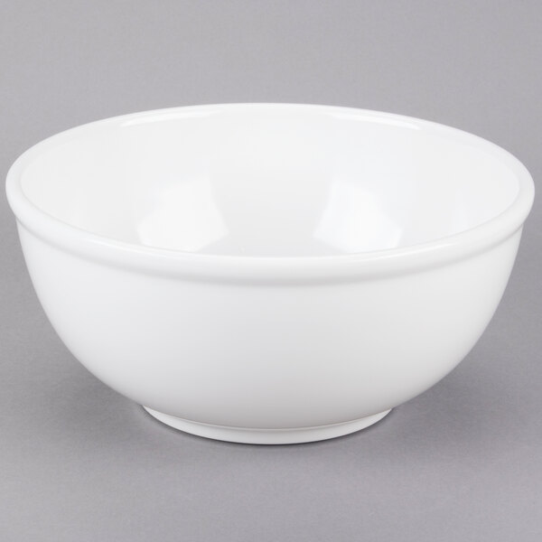 A white Cal-Mil melamine bowl on a gray surface.