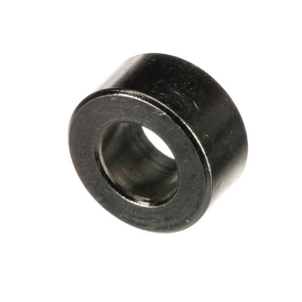 A close-up of a black metal round door bushing with a hole in the center.