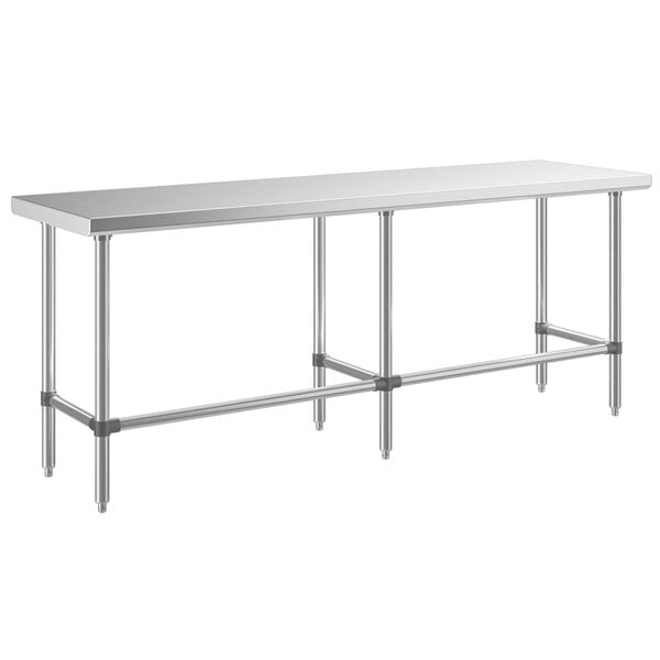A long rectangular Regency stainless steel work table with metal legs.