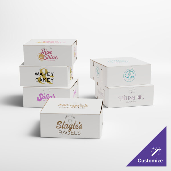 A set of customizable white bakery boxes with various printed logos and designs.