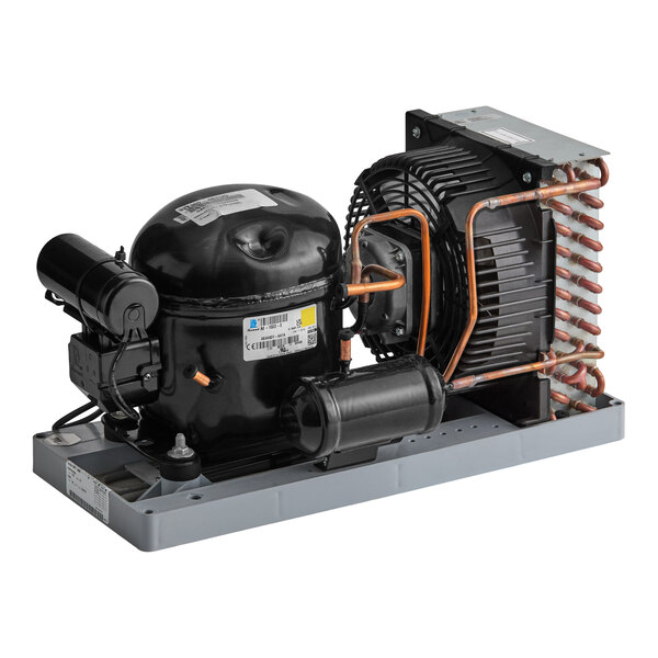 A refrigeration condensing unit with a black compressor, copper tubing, and a finned heat exchanger mounted on a gray base.
