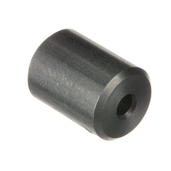 A black metal Groen water flow reducer with a hole in the center.