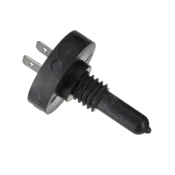 A black plastic plug with a black rubber tube on a circular object.