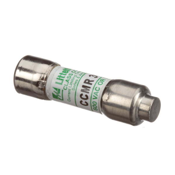 A close-up of a small silver fuse with a green label.