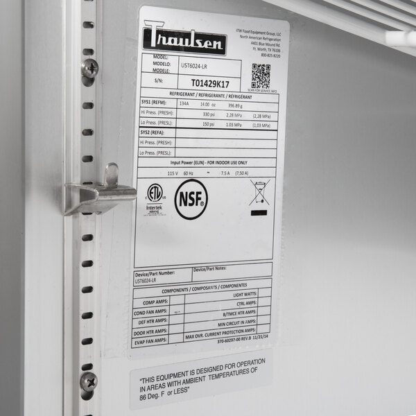 A Traulsen refrigerated sandwich prep table with two right hinged doors and a white label.