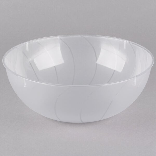 A clear plastic bowl with lines on it.