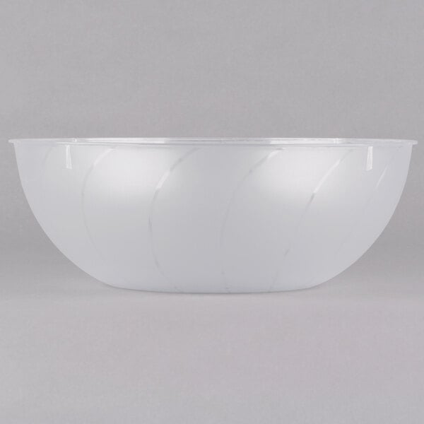 A clear plastic bowl with a white rim on a white surface.