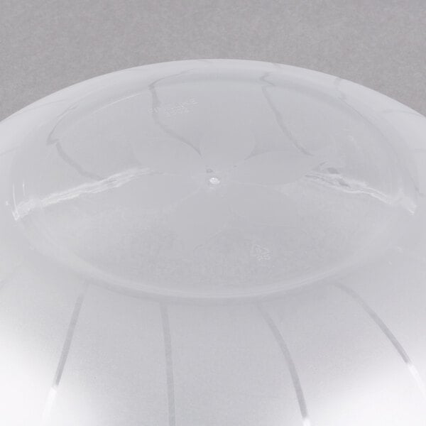 A clear plastic round bowl with a line in it.