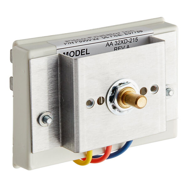 A metal box with a metal plate and wires connected to a white and yellow metal switch.