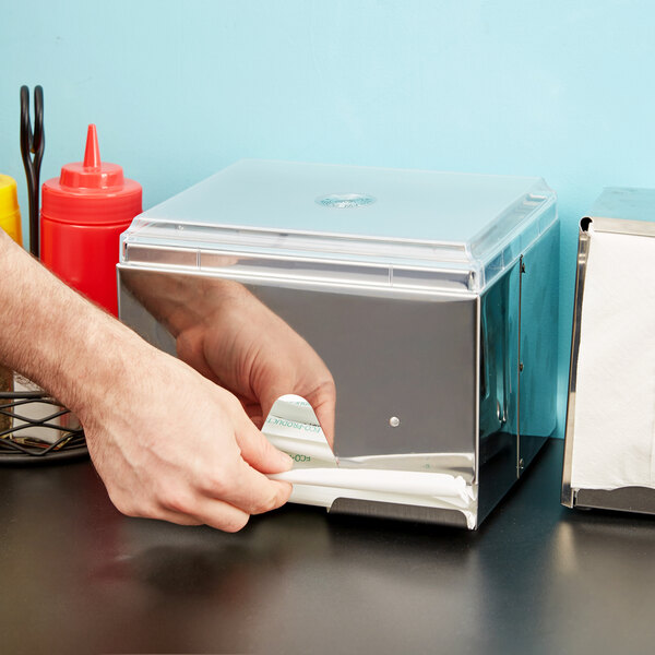 A stainless steel box with a clear lid holding wrapped straws.