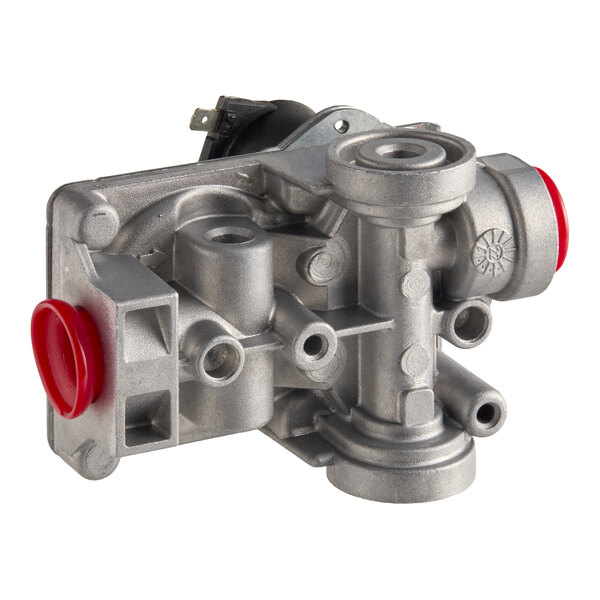A metal gas valve component with multiple ports and red protective caps.
