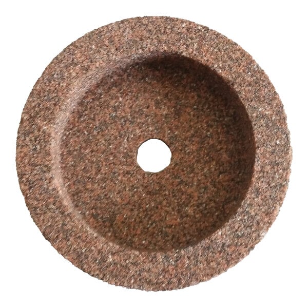 A round, coarse-textured sharpening stone with a central hole.
