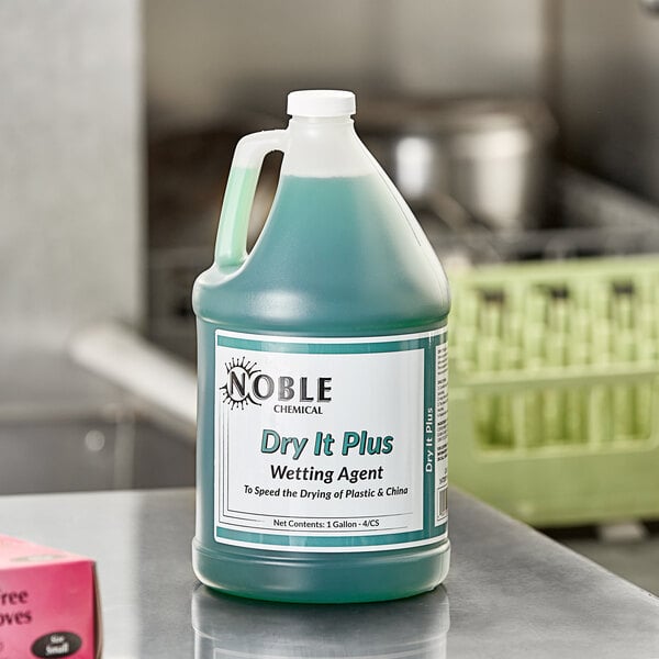 A green jug of Noble Chemical Dry It Plus sitting on a counter.