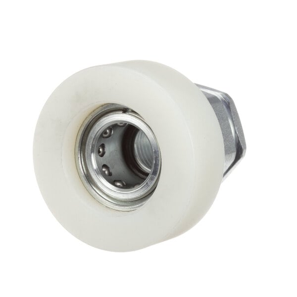 A white plastic wheel with a metal nut on a circular metal object.