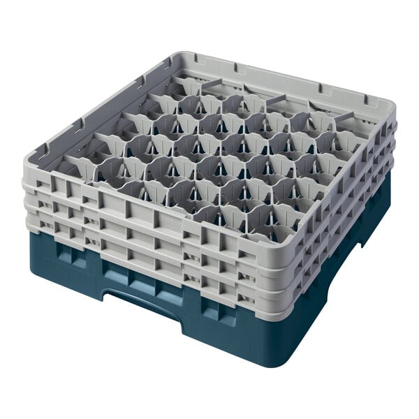A teal plastic Cambro glass rack with many compartments.