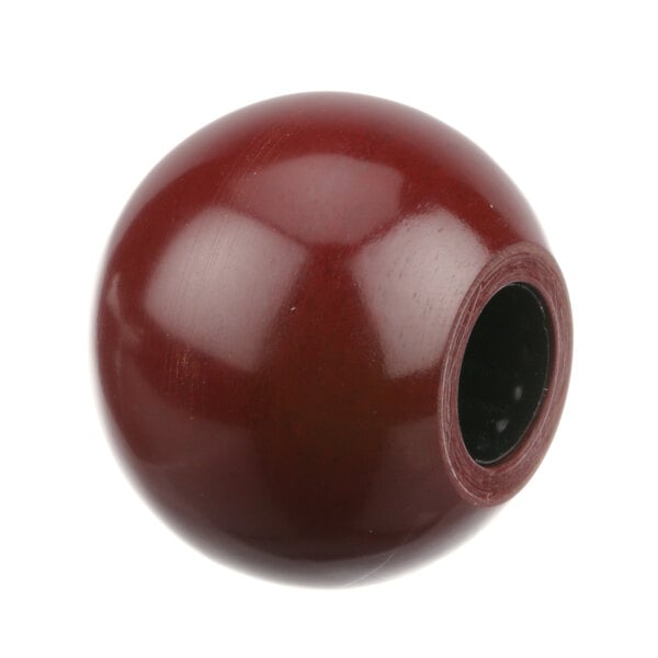 A red Crown Steam knob with a black circle on it.