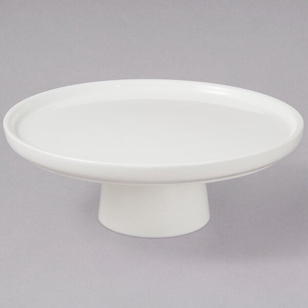 A 10 Strawberry Street Whittier white porcelain cake stand with a bowl on top.
