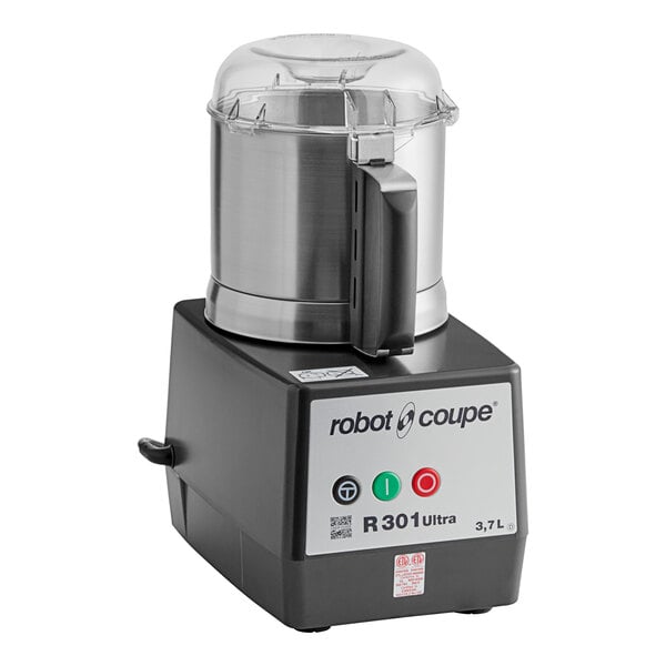 A black and silver Robot Coupe food processor with a lid on it.