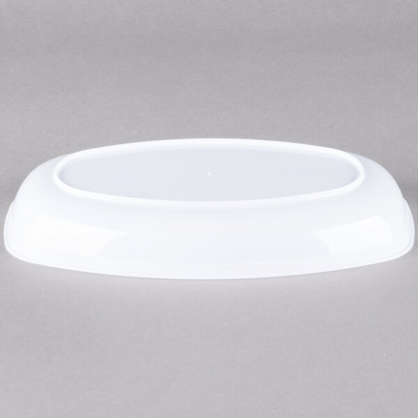 A white plastic dish on a gray background.