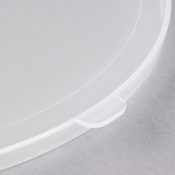 A close-up of a clear plastic lid with a small hole.