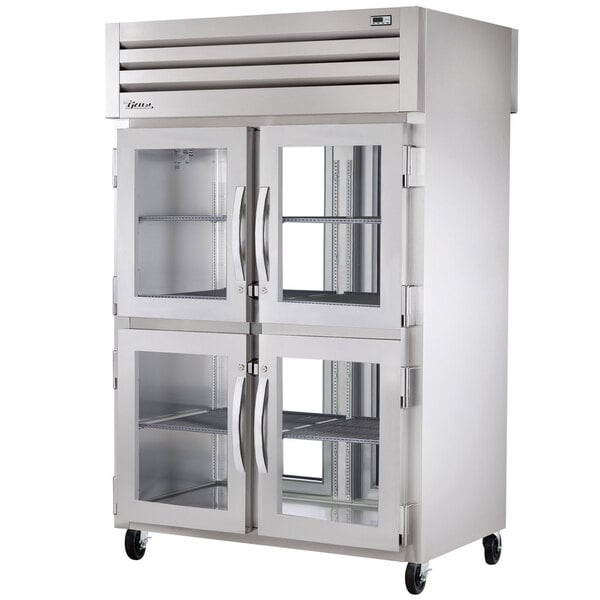 A True stainless steel pass-through refrigerator with glass doors.