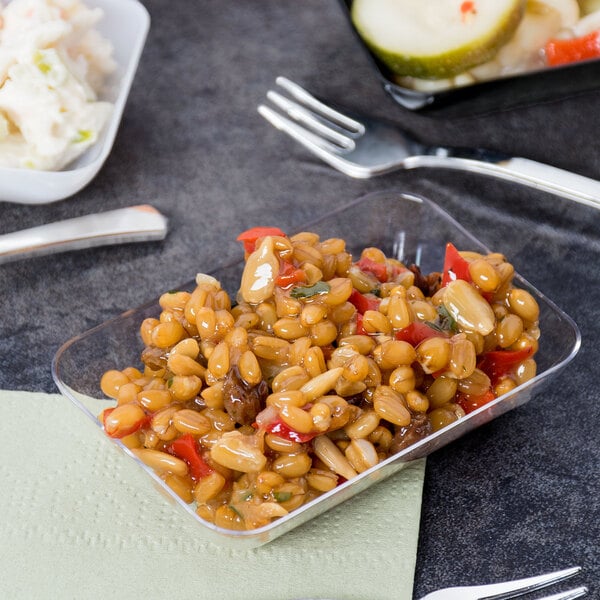 A clear Fineline rectangular tray filled with beans and vegetables on a table.