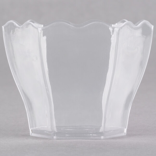 A clear plastic hexagon bowl with wavy edges.