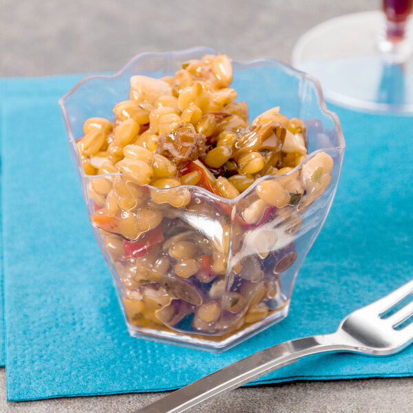 A clear plastic Fineline Tiny Hexagon Cube bowl filled with food.