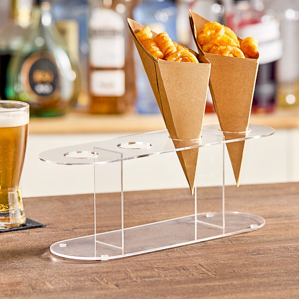 A Choice acrylic cone holder with two cones of food on a table.