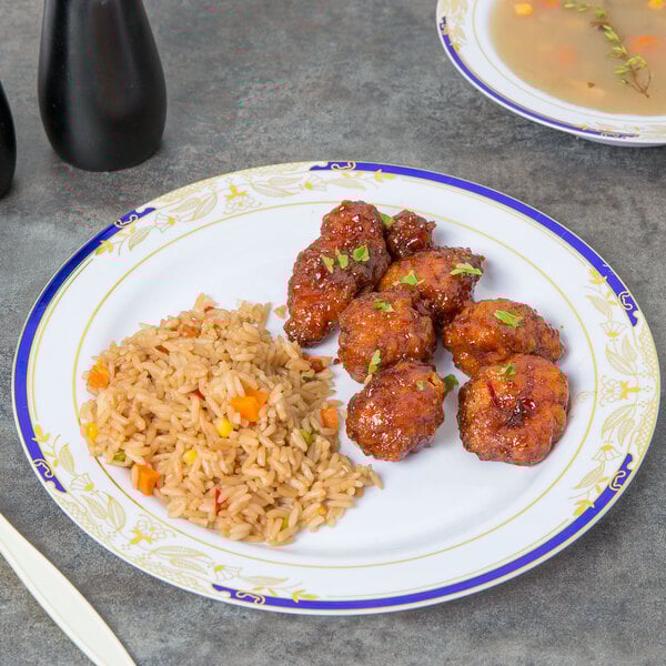 A Fineline white plastic dinner plate with blue and gold accents holding Chinese food on a table.