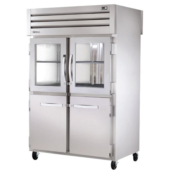 A True stainless steel pass-through refrigerator with half glass doors.