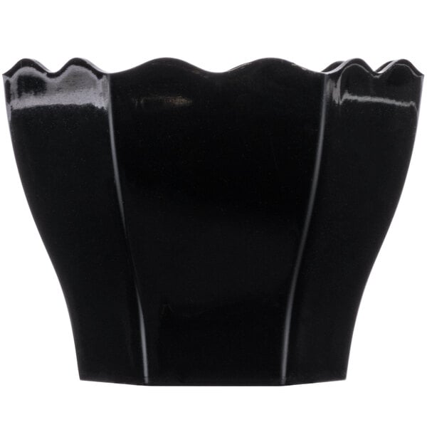 A black plastic Fineline Tiny Temptations hexagon bowl with wavy edges.