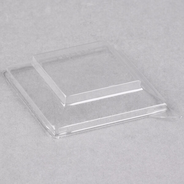 A clear plastic container with a square top.