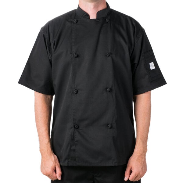 A man wearing a black Mercer Culinary chef coat with cloth knot buttons.