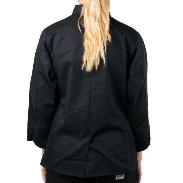 A woman wearing a black Mercer Culinary Genesis chef jacket with cloth knot buttons.
