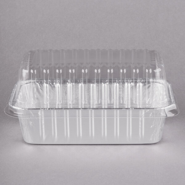 A Durable Packaging foil bread loaf pan with a clear plastic lid.
