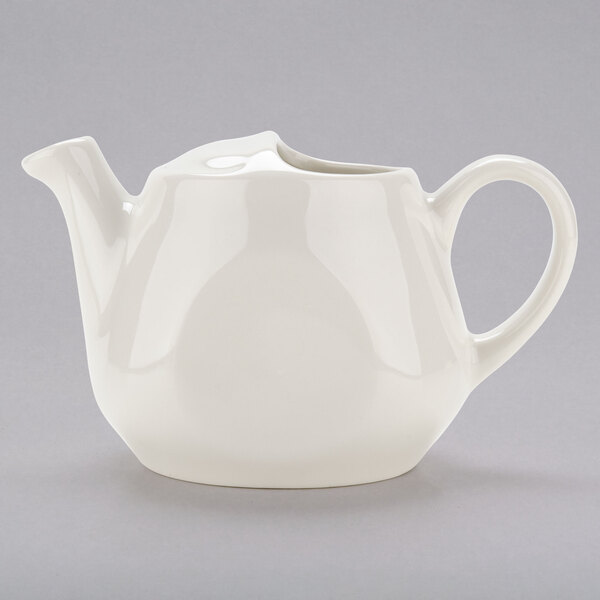 A white Tuxton Healthcare tea pot with a handle.