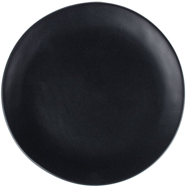 A close-up of a black 10 Strawberry Street matte wave stoneware plate.