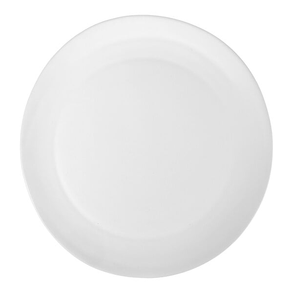A large, round, white stoneware charger plate with a matte finish.