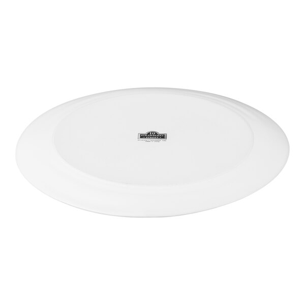 A large, round, white stoneware charger plate with a matte finish.