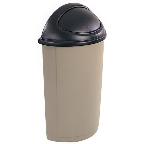 A black and tan Rubbermaid half round trash can lid with a round top swing door.